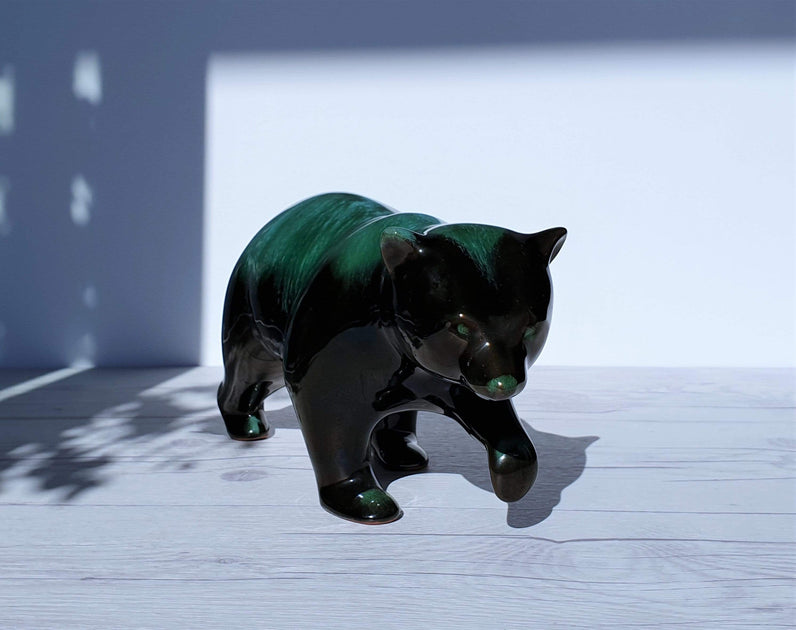 Authentic Blue Mountain Pottery walking bear in a full shot with the iconic green and black drip glaze.