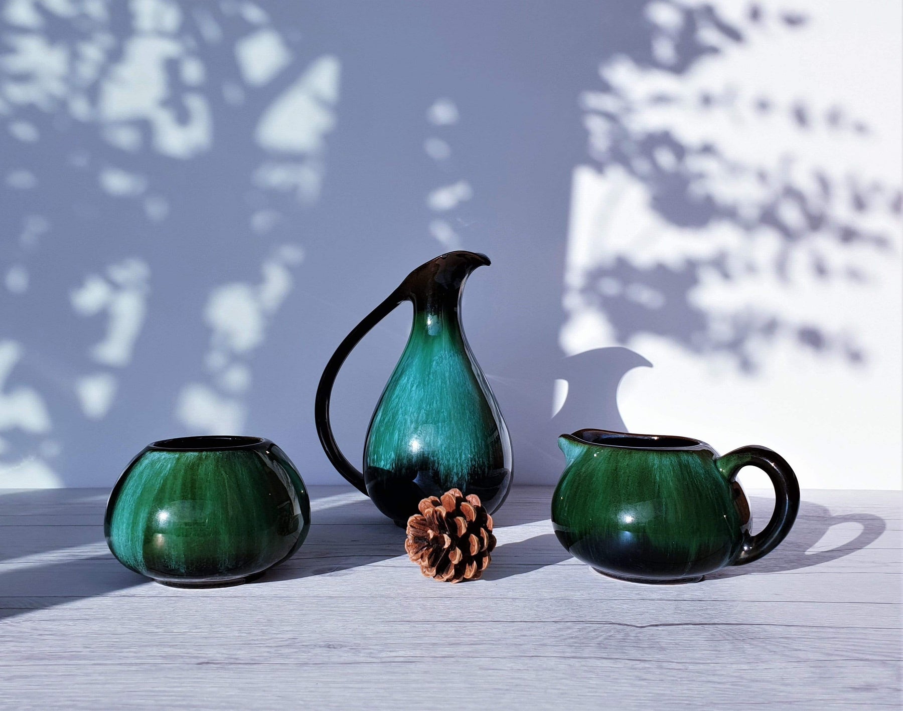 https://hautecurature.com/cdn/shop/products/anyesattic-ceramic-blue-mountain-pottery-3-piece-set-in-boreal-forest-green-and-black-glaze-dripware-1970s-canadian-15477182005317_1800x1800.jpg?v=1613829946