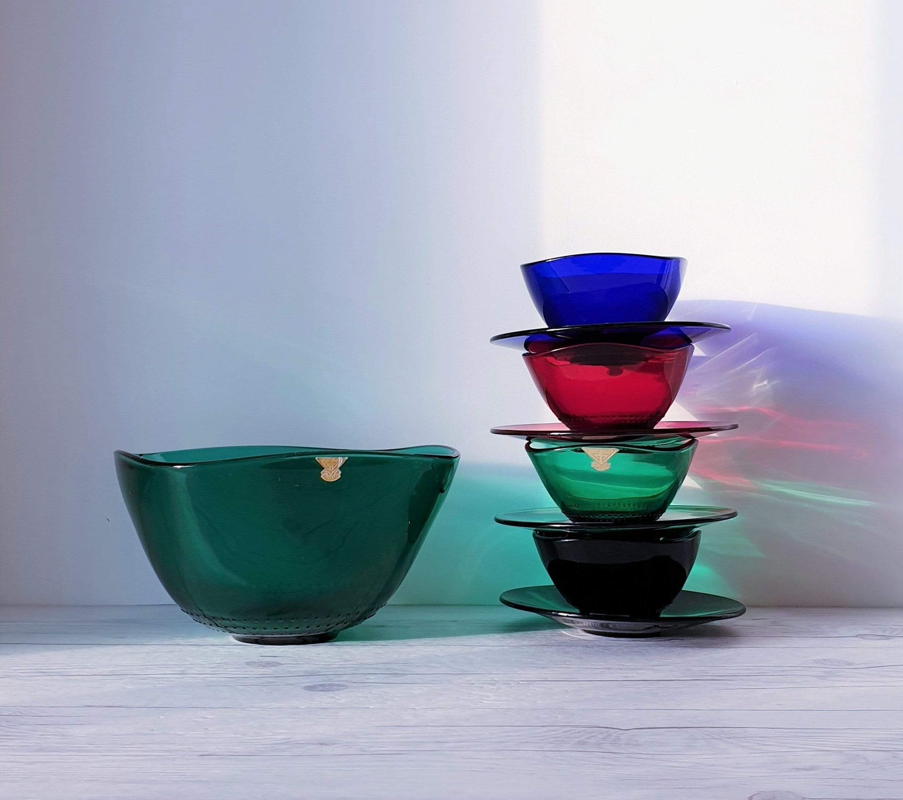 https://hautecurature.com/cdn/shop/products/anyesattic-glass-swedish-gullaskruf-4-colour-dot-relief-glass-bowl-and-saucer-set-for-4-and-serving-bowl-1960s-70s-15470334476357_1800x1800.jpg?v=1613891094